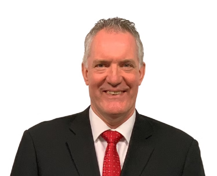 David Carl Williams wearing a black suit and red tie